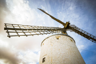 Low angle view of traditional windmill against sky