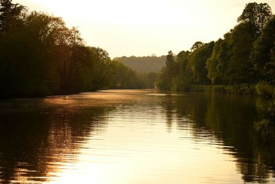 Scenic view of lake against sky at sunset