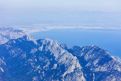 Scenic view of sea and mountains against sky