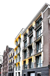 Low angle view of residential buildings against clear sky