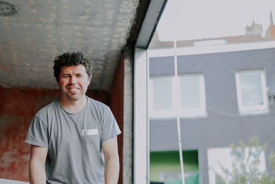 Portrait of caucasian male builder near the window.