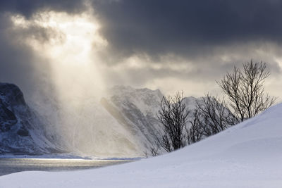 Winter sun shining through clouds over lofoten, nordland, norway, europe