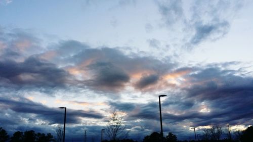 Low angle view of street light against cloudy sky