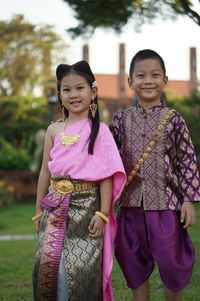 Portrait of a smiling girl standing outdoors