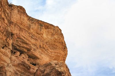 Low angle view of rock formation against sky