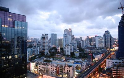 High angle view of illuminated buildings against sky in city