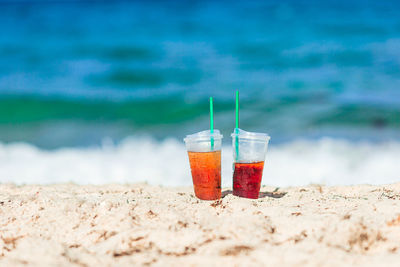 Close-up of drink on beach