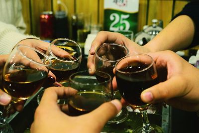 Midsection of people drinking glass