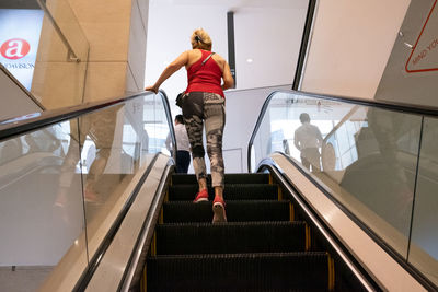 Rear view of woman walking on staircase