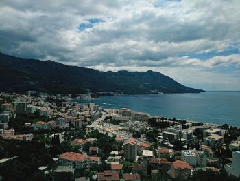 High angle view of townscape by sea against sky