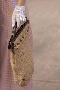 Close-up of woman holding hat