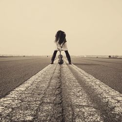 Full length of woman standing against clear sky