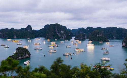 Sailboats in lake against sky