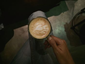 Cropped hand holding coffee cup