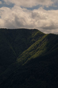 Scenic view of mountains against cloudy sky