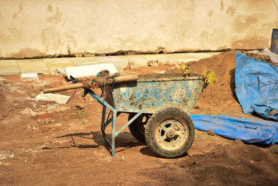Rusty wheelbarrow at construction site