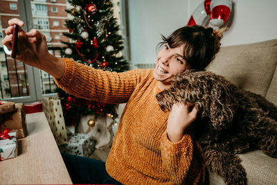 Woman with christmas tree at home