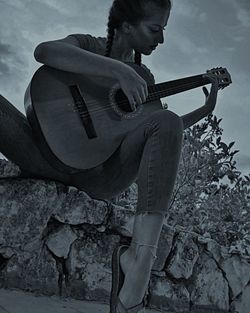 Low angle view of man playing guitar