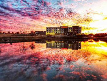 Reflection of building in lake during sunset