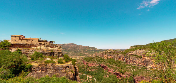 Built structure on mountain against blue sky