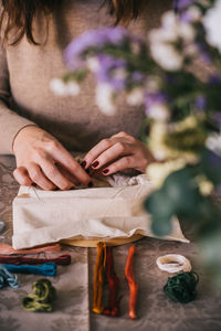 Midsection of woman holding hands