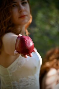 Portrait of woman holding apple