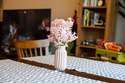 Close-up of flower vase on table at home