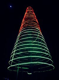 Low angle view of illuminated lights against sky at night