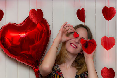 Midsection of woman holding red heart