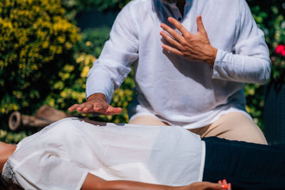 Reiki healing session. woman lying with her eyes closed, having reiki healing treatment.