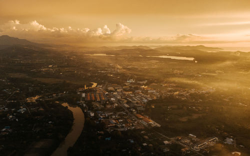 Aerial view of city against sky during sunset