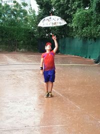 Full length of man standing on wet rainy day