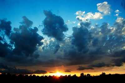 Silhouette of landscape against cloudy sky