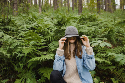 Young woman sitting in high grass