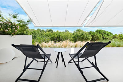 Empty chairs and tables and table at outdoor cafe