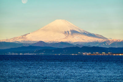 Scenic view of snowcapped mountains against clear sky