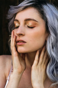 Close-up portrait of a beautiful young woman with eyes closed