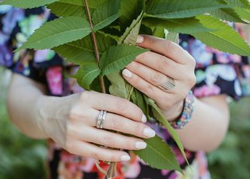 Close-up of woman holding leaf