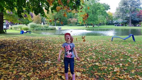 Girl playing in park during autumn