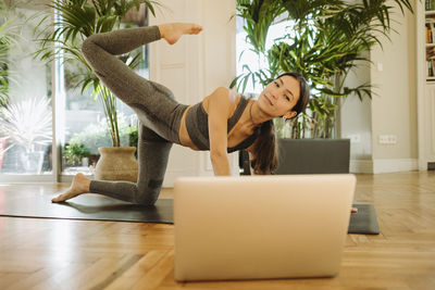 Young woman using smart phone at home