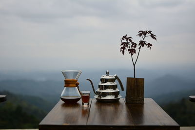 View of wine glasses on table against sky