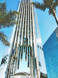 Low angle view of palm trees against sky