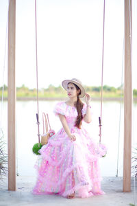 Portrait of woman standing on pink outdoors