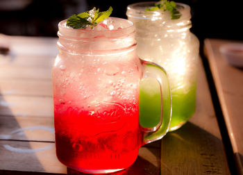 Close-up of cocktails in mason jars on table