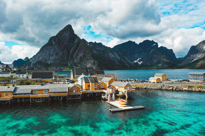 Aerial view of a fishing village with yellow cabins in lofoten norway