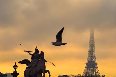 Low angle view of statue against cloudy sky