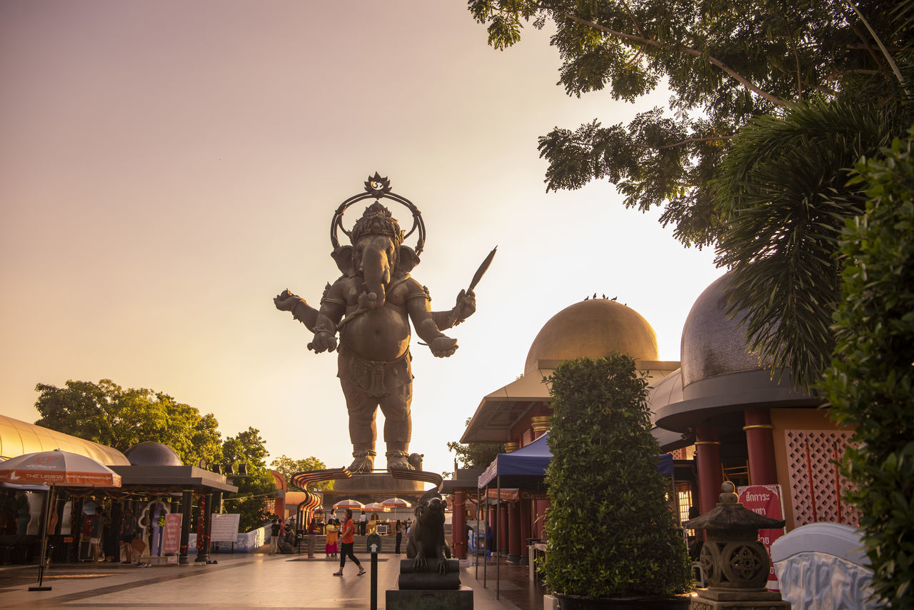 architecture, tree, plant, sculpture, nature, statue, sky, built structure, religion, travel destinations, travel, building, building exterior, sunset, city, temple, belief, history, outdoors, representation, the past, tourism, spirituality