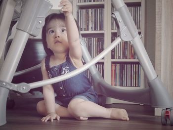 Full length of girl sitting on floor