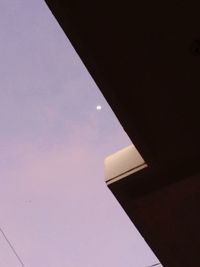 Low angle view of illuminated lamp against sky at night