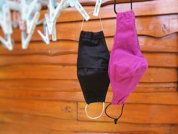 Close-up of multi colored clothespins hanging on wood